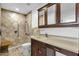 The bathroom features a walk-in shower with a bench and grab bar, along with a vanity at 5358 S Farmer Ave, Tempe, AZ 85283