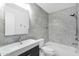 Modern bathroom features marble tile, sleek vanity, and a shower-tub combination at 5358 S Farmer Ave, Tempe, AZ 85283