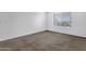 A carpeted bedroom with a window letting in natural light creates a cozy and inviting space at 5358 S Farmer Ave, Tempe, AZ 85283