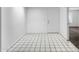 A well lit foyer with checkered tile flooring and a white front door at 5358 S Farmer Ave, Tempe, AZ 85283