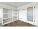 Utility storage room with built-in shelving and access door in garage at 5358 S Farmer Ave, Tempe, AZ 85283