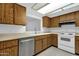 Eat-in kitchen featuring a stainless steel dishwasher, white countertops, and white oven at 5358 S Farmer Ave, Tempe, AZ 85283