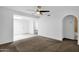 Open concept living room, featuring neutral carpet, ceiling fan, and light-colored walls at 5358 S Farmer Ave, Tempe, AZ 85283