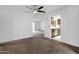 Open concept living room featuring ceiling fan, neutral carpet, and doorway to kitchen at 5358 S Farmer Ave, Tempe, AZ 85283