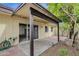 The covered patio area with brick accents overlooks mature trees and an orange tree at 5358 S Farmer Ave, Tempe, AZ 85283