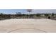 Community basketball court, promoting active lifestyle and recreation with clear lines, hoop, and seating at 5551 S 240Th Ln, Buckeye, AZ 85326