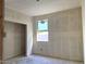 Bright unfinished bedroom with natural light, showcasing a flexible space for customization and comfort at 5551 S 240Th Ln, Buckeye, AZ 85326