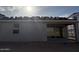 Home exterior with covered patio and sliding glass doors, perfect for entertaining and relaxation at 5551 S 240Th Ln, Buckeye, AZ 85326