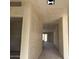 Unfinished hallway featuring textured walls and doorway to another room at 5551 S 240Th Ln, Buckeye, AZ 85326