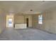 Spacious unfinished living room with window to the exterior at 5551 S 240Th Ln, Buckeye, AZ 85326