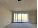 Unfinished Living room with sliding glass doors to the backyard at 5551 S 240Th Ln, Buckeye, AZ 85326