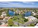 Residential area with houses surrounding a lake, featuring lush landscaping and mountain views at 5632 S Hurricane Ct # C, Tempe, AZ 85283