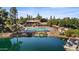 Aerial view of the community clubhouse, pool, landscaping, and lake with docks at 5632 S Hurricane Ct # C, Tempe, AZ 85283
