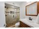 Bathroom featuring a glass enclosed shower, wood vanity, and an updated sink at 5632 S Hurricane Ct # C, Tempe, AZ 85283