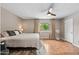 Cozy bedroom with a large window, wood floors, ceiling fan and plenty of light at 5632 S Hurricane Ct # C, Tempe, AZ 85283