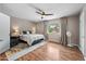 Spacious bedroom featuring wood floors, ceiling fan, a large window and natural light at 5632 S Hurricane Ct # C, Tempe, AZ 85283