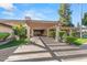 Community clubhouse entrance featuring a covered walkway, mature trees, and manicured lawns at 5632 S Hurricane Ct # C, Tempe, AZ 85283