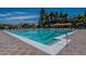 Large community pool with lap lanes, surrounded by lounge chairs, palm trees, and colorful flags at 5632 S Hurricane Ct # C, Tempe, AZ 85283