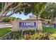 The Lakes Beach and Tennis Club entrance sign with colorful flowers and manicured landscaping at 5632 S Hurricane Ct # C, Tempe, AZ 85283