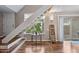 Stylish entryway featuring an open staircase, warm wood floors, and decorative accents at 5632 S Hurricane Ct # C, Tempe, AZ 85283