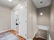 Hallway featuring wood floors, white doors, and a modern light fixture hanging near the staircase at 5632 S Hurricane Ct # C, Tempe, AZ 85283