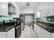 Modern kitchen featuring stainless steel appliances, white cabinets, and stone countertops at 5632 S Hurricane Ct # C, Tempe, AZ 85283