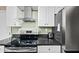 Modern kitchen featuring stainless steel appliances, black countertops, and sleek white cabinetry at 5632 S Hurricane Ct # C, Tempe, AZ 85283