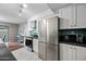Well-lit kitchen with stainless appliances, white cabinets, and convenient layout at 5632 S Hurricane Ct # C, Tempe, AZ 85283