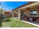 View of the covered patio featuring lush grass, patio furniture and covered grill at 6413 S 47Th Dr, Laveen, AZ 85339