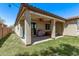 Spacious covered patio with a backyard featuring lush grass and outdoor cooking area at 6413 S 47Th Dr, Laveen, AZ 85339