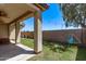 Relaxing covered patio with backyard featuring lush green grass and a swing set at 6413 S 47Th Dr, Laveen, AZ 85339