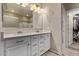 Elegant bathroom with a double vanity, white cabinetry, and access to a walk-in closet at 6413 S 47Th Dr, Laveen, AZ 85339