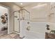 Well-lit bathroom featuring a glass-enclosed shower and a separate soaking tub at 6413 S 47Th Dr, Laveen, AZ 85339