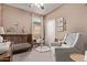 Cozy neutral-toned Bedroom featuring a crib, comfortable chair and decorative wall art at 6413 S 47Th Dr, Laveen, AZ 85339