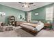 Inviting bedroom featuring a green accent wall and a cozy seating area at 6413 S 47Th Dr, Laveen, AZ 85339