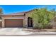 Charming single-story home featuring a tile roof, two-car garage, and desert landscaping at 6413 S 47Th Dr, Laveen, AZ 85339