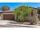 Street view of a single-story home with a desert landscape and a two-car garage at 6413 S 47Th Dr, Laveen, AZ 85339