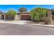 Street view of a single-story home with desert landscaping, a tile roof, and a two-car garage at 6413 S 47Th Dr, Laveen, AZ 85339