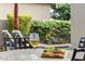 Outdoor patio featuring a wine and charcuterie board on a table, with a pool and lounge area in the background at 6929 E Montreal Pl, Scottsdale, AZ 85254
