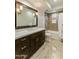 Bathroom featuring a dark wood vanity with white countertop and a shower/tub combo with tile surround at 6929 E Montreal Pl, Scottsdale, AZ 85254