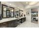 Bright bathroom with marble floors, dual sinks, vanity, and framed mirrors at 6929 E Montreal Pl, Scottsdale, AZ 85254