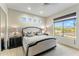 Bright bedroom with a king bed, neutral decor, and a large window offering a view of the outdoor scenery at 6929 E Montreal Pl, Scottsdale, AZ 85254