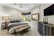 A spacious bedroom with a tufted king-sized bed, modern decor, and natural light filtering through the windows at 6929 E Montreal Pl, Scottsdale, AZ 85254