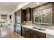 Gourmet kitchen featuring dark wood cabinetry, quartz countertops, stainless steel appliances, and designer backsplash at 6929 E Montreal Pl, Scottsdale, AZ 85254