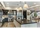 Modern kitchen with a large island, pendant lighting, stainless steel appliances, and custom cabinets at 6929 E Montreal Pl, Scottsdale, AZ 85254
