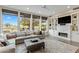 Bright living room with large windows, fireplace, and a comfortable sectional sofa at 6929 E Montreal Pl, Scottsdale, AZ 85254