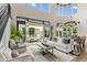 Bright living room featuring high ceilings, large windows, hardwood floors, and access to an outdoor patio at 6929 E Montreal Pl, Scottsdale, AZ 85254