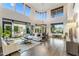 Open-concept living room with hardwood floors, high ceilings, and an abundance of natural light at 6929 E Montreal Pl, Scottsdale, AZ 85254