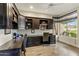 Home office with custom dark wood built-ins and a large window for natural light at 6929 E Montreal Pl, Scottsdale, AZ 85254