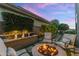 Landscaped backyard with a fire pit, water feature, and comfortable seating, perfect for enjoying the outdoors at 6929 E Montreal Pl, Scottsdale, AZ 85254